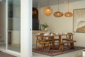 a dining room with a table and chairs at SandWave Villa by Betterplace in Ungasan