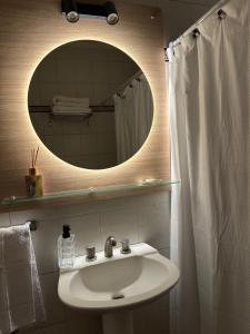 a bathroom with a sink and a mirror at Mendoza908 in Nueve de Julio +58 photos