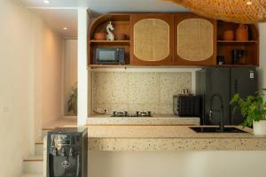 a kitchen with a sink and a counter top at SandWave Villa by Betterplace in Ungasan