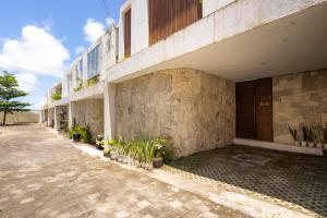a building with plants on the side of it at SandWave Villa by Betterplace in Ungasan