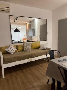 a couch in a living room with a large mirror at Mendoza908 in Nueve de Julio