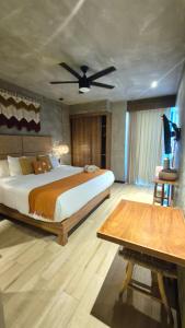 a bedroom with a bed and a ceiling fan at Amplio Estudio con Balcon Tuk 004 in Tulum +13 photos
