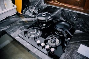 a stove top with pots and pans on top of it at Paddy Breeze Villa in Batigama +9 photos