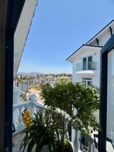 a view from the balcony of a white building at Bibo House - Near Xuan Huong Lake & Center in Da Lat