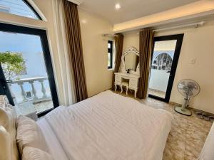 a bedroom with a bed and a large window at Bibo House - Near Xuan Huong Lake & Center in Da Lat