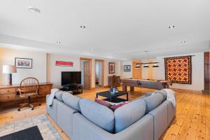 a living room with a couch and a pool table at Fiddler Lake Resort - Deer 68 in Mille-Isles