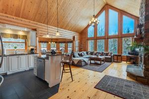 a kitchen and living room in a log cabin at Fiddler Lake Resort - Deer 68 in Mille-Isles