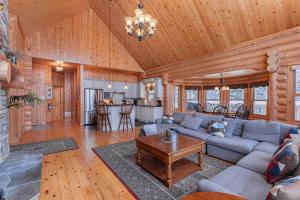 a living room with a couch and a table at Fiddler Lake Resort - Deer 68 in Mille-Isles