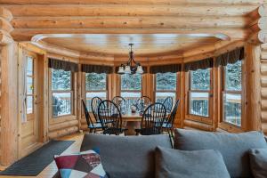 a dining room with a table and chairs and windows at Fiddler Lake Resort - Deer 68 in Mille-Isles +21 photos