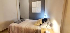 a bedroom with a bed with a laptop on it at Departamento boutique céntrico in San Miguel de Tucumán