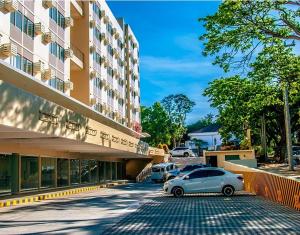 a car parked in front of a building at The Cozy Place Stanford 2 in Silang