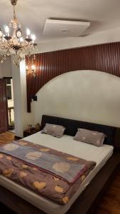 a large bed in a bedroom with a chandelier at Kings Palace in Kathmandu