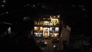 a large building with lights on it at night at Kings Palace in Kathmandu