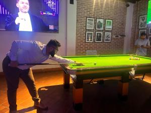 a man standing in front of a pool table at Kings Palace in Kathmandu