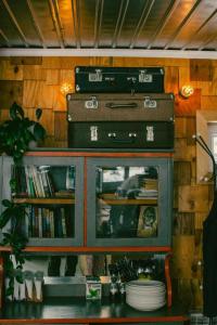 a book shelf with suitcases on top of it at Duet hostel in Karakol
