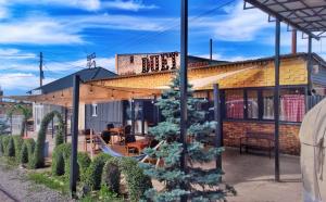 a building with a christmas tree in front of it at Duet hostel in Karakol