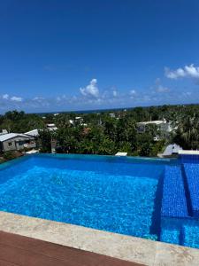 a swimming pool with a view of the ocean at Hotel Down Town Cabrera in Cabrera