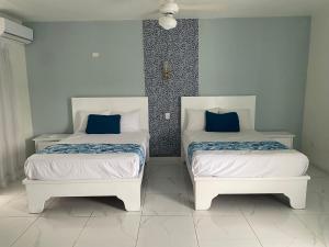 two beds sitting next to each other in a room at Hotel Down Town Cabrera in Cabrera +25 photos