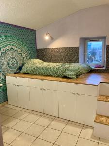 a bedroom with a bed on top of a counter at Chez Corinne in Valence