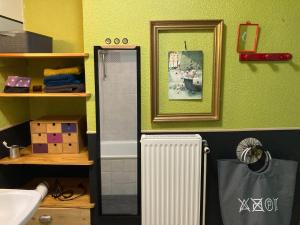 a bathroom with a white radiator and a mirror at Chez Corinne in Valence +32 photos