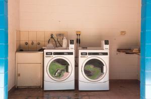 a laundry room with two washing machines in it at Banyan Tree Holiday Park in Rum Jungle Station
