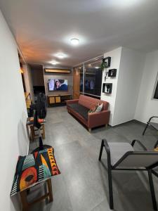 a living room with a couch and a tv at Comodidad, sol y descanso total in Melgar