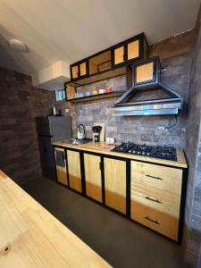 a kitchen with a stove and a refrigerator at Comodidad, sol y descanso total in Melgar