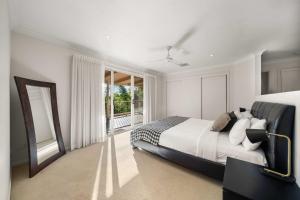 a bedroom with a large bed and a large window at Hinterland Tranquil Escape with Beautiful Views in Ninderry +34 photos
