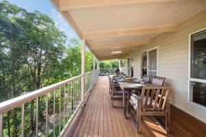a porch with a table and chairs on it at Hinterland Tranquil Escape with Beautiful Views in Ninderry