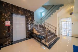 a hallway with a staircase in a building at DF Hotel Pattaya in Pattaya South