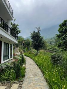 a stone path next to a house with a view at emoi valley bavi in Ba Vì