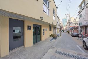 an empty street with a building with a door at Travel Home in Seoul