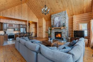 a living room with couches and a fireplace at Fiddler Lake Resort - Deer 69 in Mille-Isles