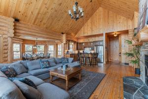 a living room with a couch and a table at Fiddler Lake Resort - Deer 69 in Mille-Isles