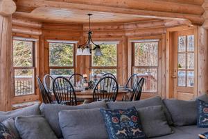 a living room with a couch and a table with chairs at Fiddler Lake Resort - Deer 69 in Mille-Isles +19 photos