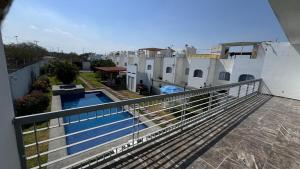 a balcony of a house with a swimming pool at Home in Tequesquitengo in Tequesquitengo