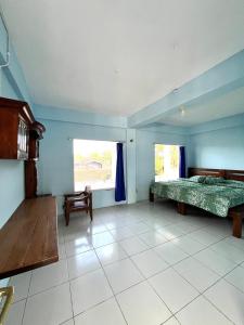 a bedroom with a bed and a chair in it at Tilamsari Hotel in Wonosari