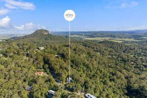 an aerial view of a sign in the middle of a forest at Hinterland Tranquil Escape with Beautiful Views in Ninderry