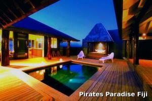 a house with a swimming pool and a fireplace at Luxury Ocean View Villa, Savusavu Bay, Blue Bayou Bure with Starlink in Savusavu