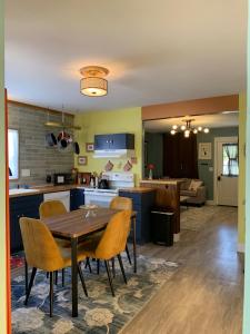 a kitchen and living room with a table and chairs at Poppy's Place in Chanute