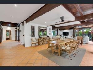 a dining room with a table and chairs at Solander Beachfront with private beach access & pool in Port Douglas