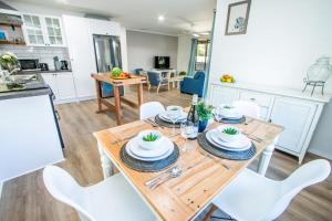 a kitchen and dining room with a wooden table and chairs at Canny Breeze in Agnes Water