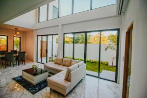 a living room with a couch and a table at The Hide Private in Ban Non Sa-at