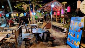 a restaurant with a table and chairs and lights at Do Dee cafe in Bangkok