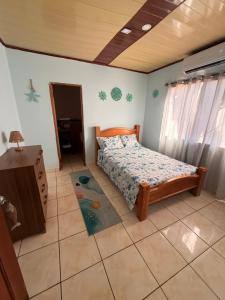 a bedroom with a bed in a room at BREEZE Hostal Boca Chica in Boca Chica