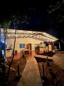 a building with a table in front of it at night at BREEZE Hostal Boca Chica in Boca Chica
