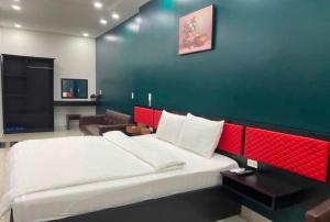 a bedroom with a large bed with a red headboard at Hưng Phú Hotel HCM in Ho Chi Minh City +49 photos