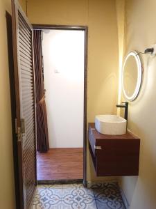 a bathroom with a sink and a mirror at Dieng Latar Alam Tambi Syariah in Kejajar +39 photos
