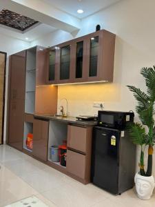 a kitchen with a counter with a sink and a microwave at isuites in Ghaziabad