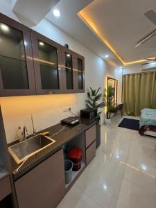 a kitchen with a sink and a counter top at isuites in Ghaziabad